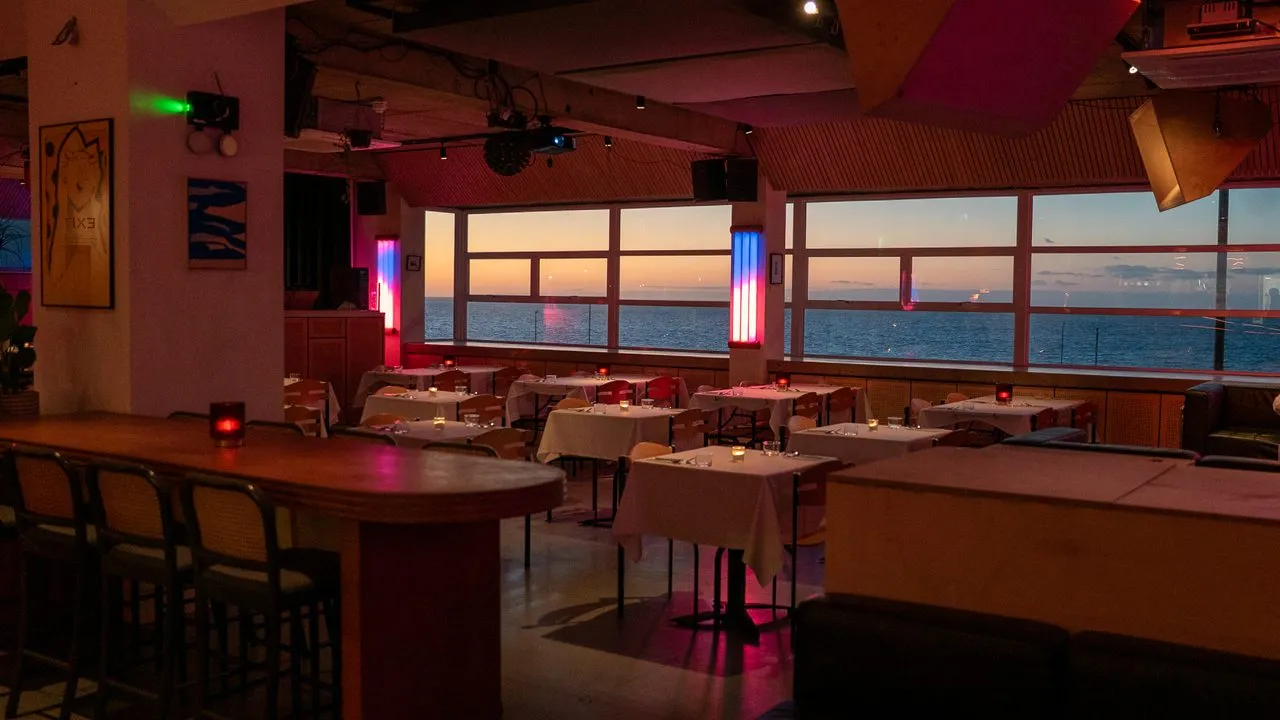 Faith In Strangers, the candlelit sea-view room at dusk